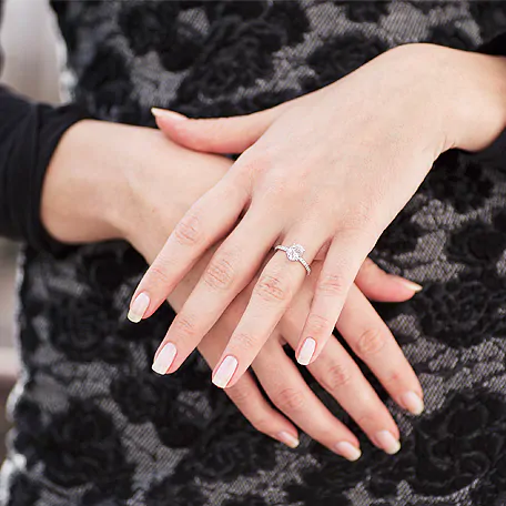 Woman wearing a big diamond ring.
